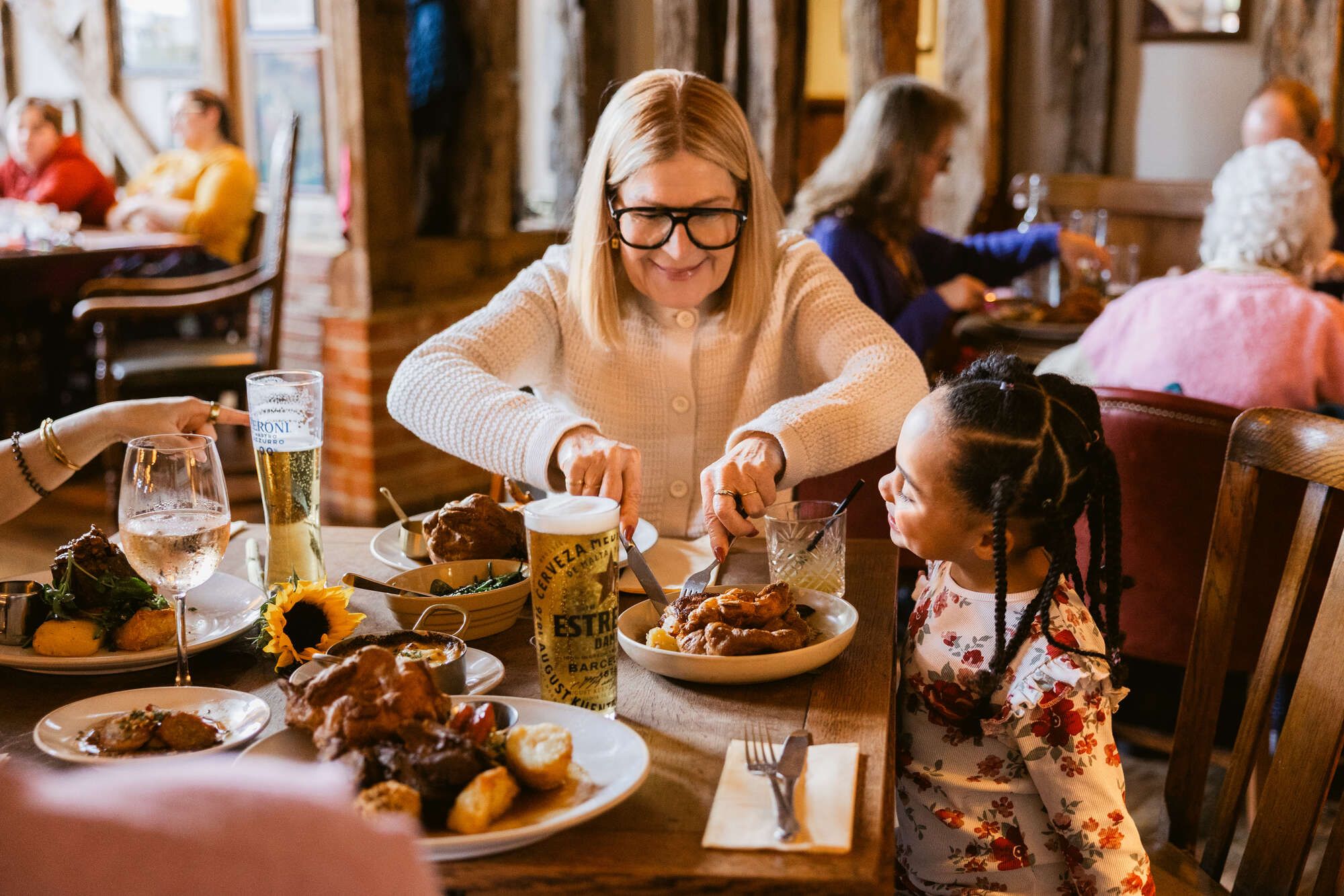Grandma and grand daughter eating roast together