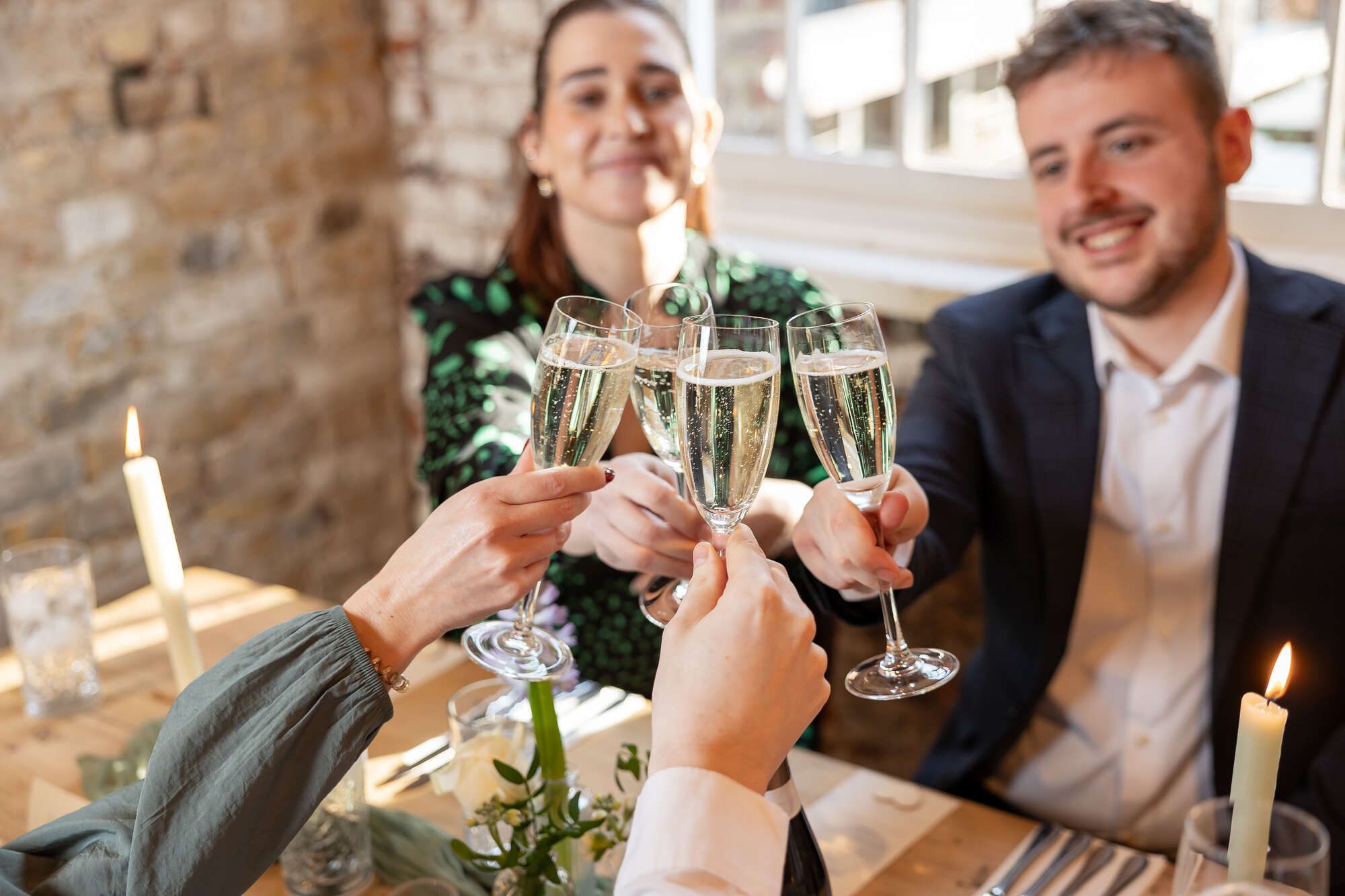 Celebration woth cheers and 3 ppl with sparkling wine