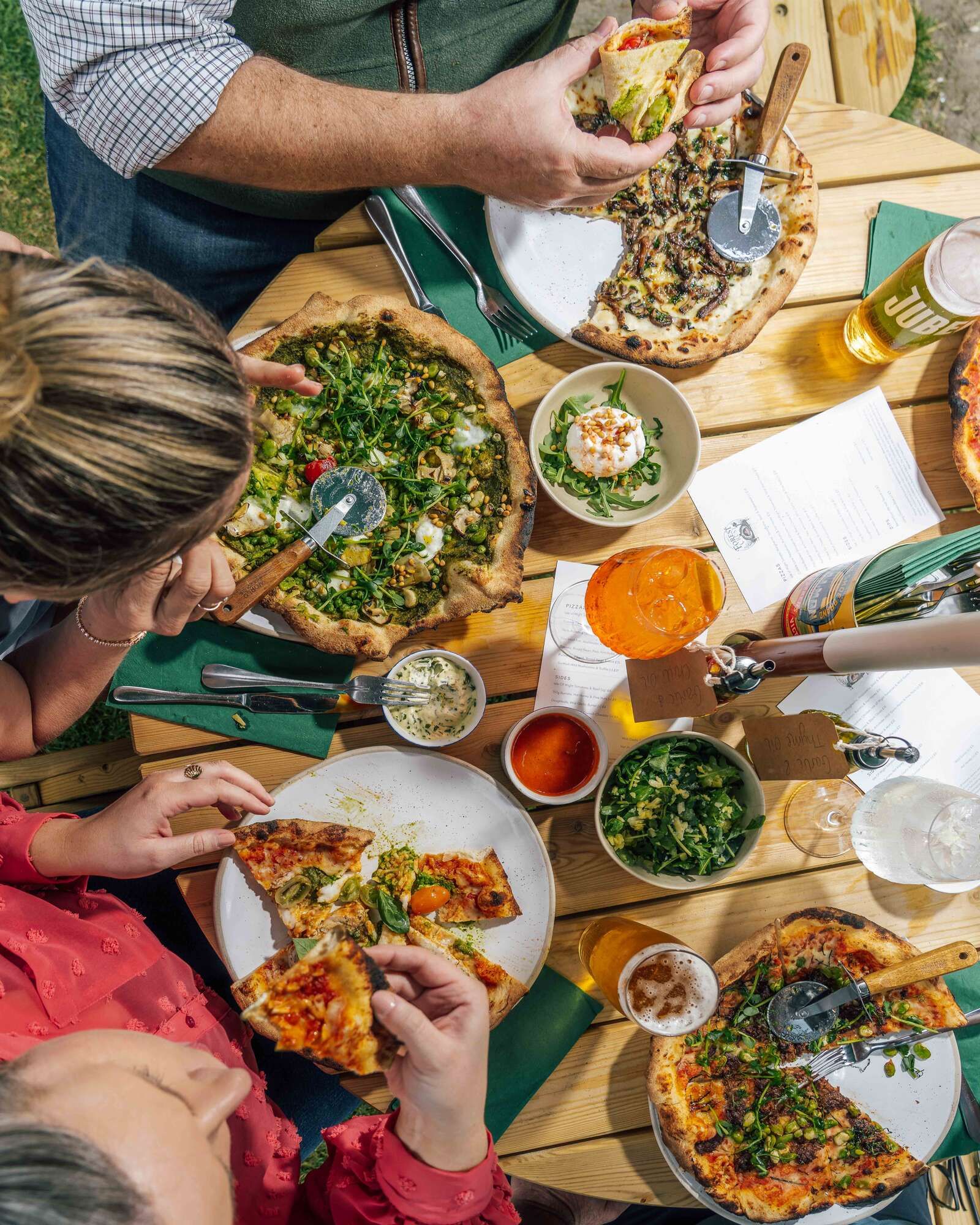 Selection of Pizzas outside by the river with a selection of Spritz and chilled drinks