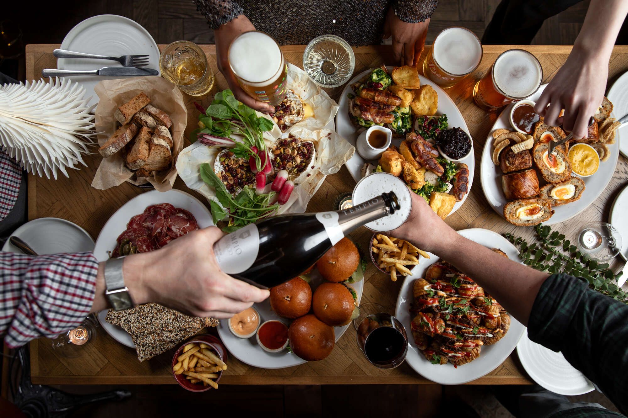 Christmas food, with prosecco pouring with friends